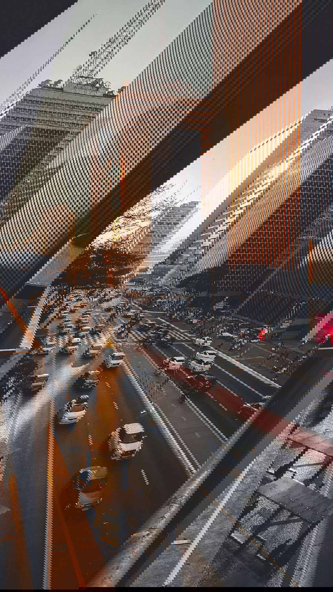 A city street filled with lots of traffic next to tall buildings